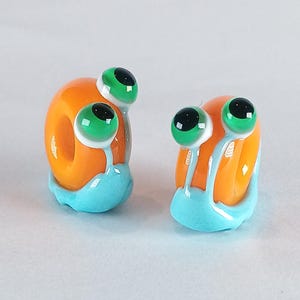 Orange lampwork Snail Beads: Handmade Glass Charm Bead with 5mm Hole for braids, shoelaces, Dreadlocks and more...