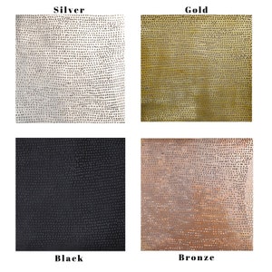 May include: Four square samples of metal with a textured surface. The samples are labeled "Silver", "Gold", "Black", and "Bronze".