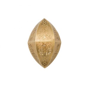 May include: A gold-colored metal wall sconce with an elongated, pointed oval shape. The surface features intricate, laser-cut filigree patterns throughout, allowing light to pass through the decorative cutouts in a symmetrical, ornate design.