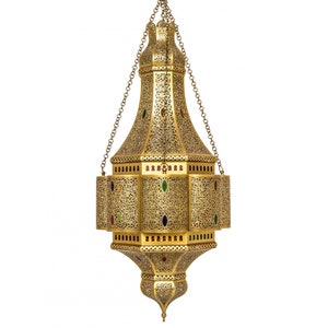 May include: A gold metal Moroccan pendant light with intricate cutouts and colorful glass accents.