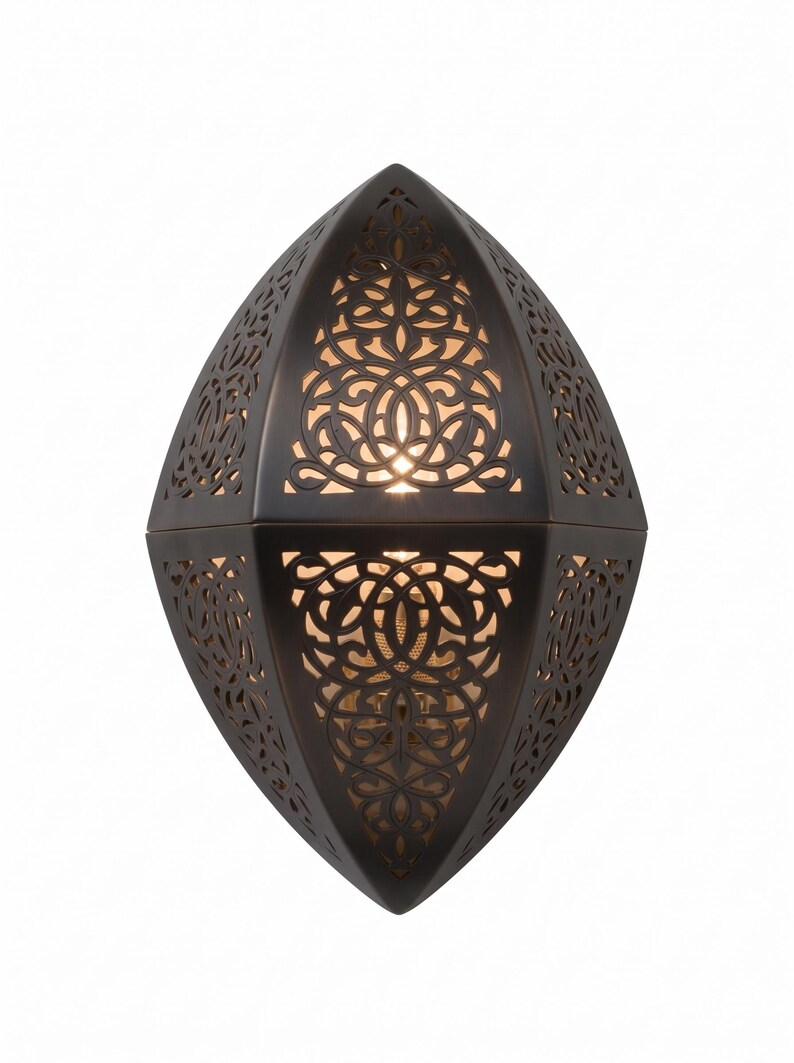 May include: A dark brown, almond-shaped wall sconce featuring intricate, laser-cut filigree patterns. The metal frame has a matte finish, and warm light glows from within the cutouts, casting a soft illumination through the decorative design.