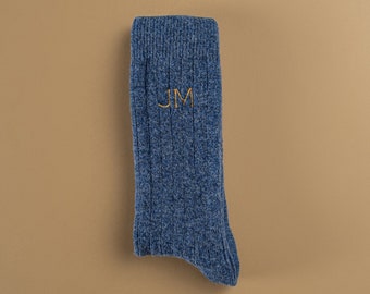 May include: A blue ribbed sock with the initials "JM" embroidered in gold thread.