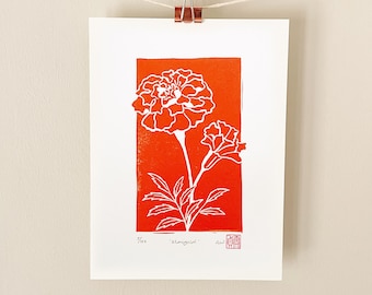 May include: A white marigold flower print on an orange background. The print is titled "Marigold" and is signed by the artist.