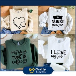 May include: Four different sweatshirts with various designs and text. The first sweatshirt is beige with a stethoscope and heart design and the text "Nurse". The second sweatshirt is grey with a nurse's cap and the text "NURSE power". The third sweatshirt is green with a coffee cup and the text "My blood TYPE IS coffee". The fourth sweatshirt is white with a stethoscope and heart design and the text "I LOVE my job".