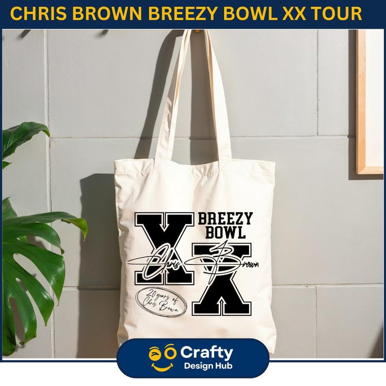 May include: Cream-colored tote bag with black text that reads "BREEZY BOWL" and "CHRIS BROWN" with a signature graphic. The bag also has the text "20 years of Chris Brown" and "Crafty Design Hub".