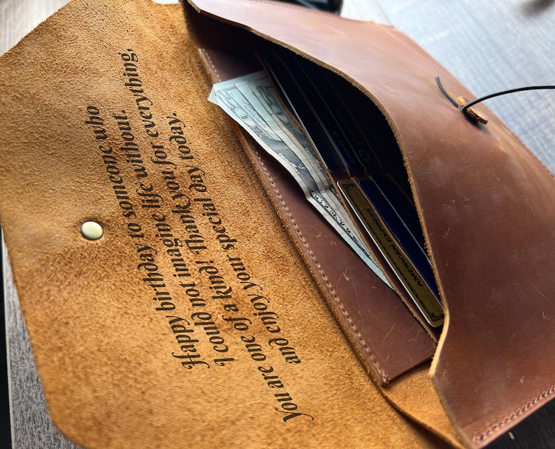 May include: A brown leather wallet with a personalized inscription that reads "Happy birthday to someone who I could not imagine life without. You are one of a kind! Thank you for everything, and enjoy your special day today."