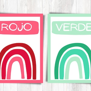 May include: Two printable cards with rainbow designs. The card on the left is pink with a red rainbow and the word "ROJO" in white. The card on the right is green with a green rainbow and the word "VERDE" in white.