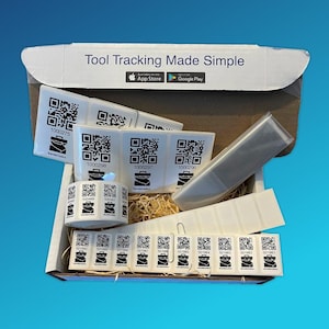 May include: A cardboard box containing tool tracking labels. The labels are white with black QR codes and the text "Tool Tracking Made Simple". The box also contains a clear plastic sleeve and a roll of labels.
