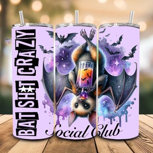 May include: A purple tumbler featuring a bat drinking a purple and orange beverage. The tumbler is inscribed with the text "Bat Shit Crazy Social Club".