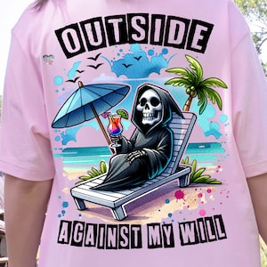 May include: A pink t-shirt with a graphic of a skeleton wearing a hooded robe, sitting in a beach chair with a tropical drink. The text "OUTSIDE AGAINST MY WILL" is printed below the graphic.