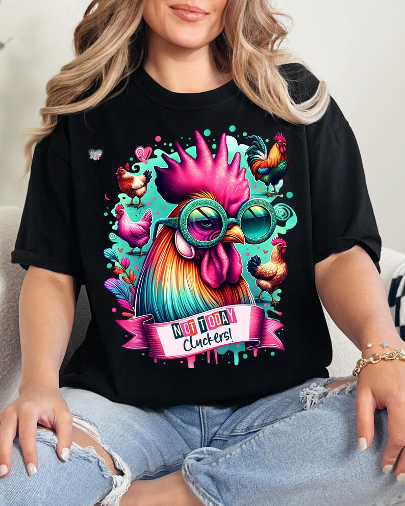 May include: Black t-shirt with a colorful rooster wearing sunglasses and a banner that says "Not Today Cluckers!"