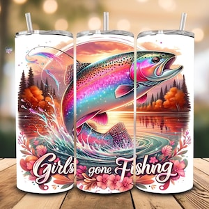May include: A white tumbler with a colorful illustration of a rainbow trout jumping out of the water. The background is a sunset scene with trees and flowers. The text "Girls gone Fishing" is printed on the tumbler.