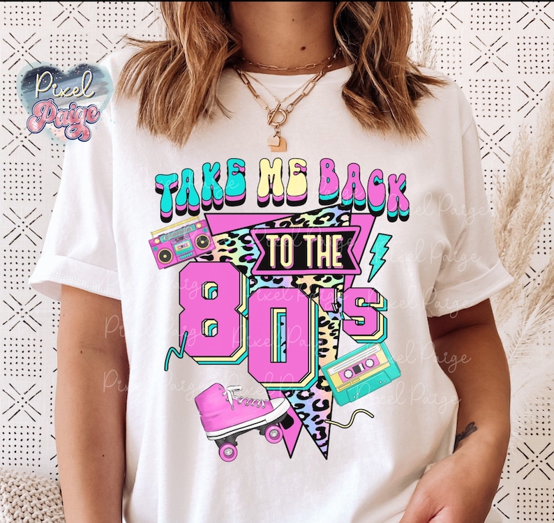 May include: White t-shirt with a graphic design that says "Take Me Back To The 80's". The graphic includes a cassette tape, roller skates, and a boombox.