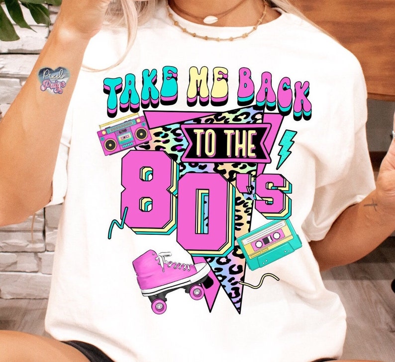 May include: White t-shirt with a graphic print of a retro roller skate, a cassette tape, and a boombox. The text on the shirt reads "Take Me Back To The 80's".