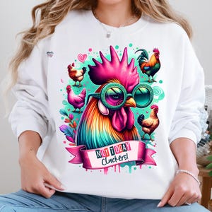 May include: White sweatshirt with a colorful rooster wearing sunglasses and the text "Not Today Cluckers!" printed on it.