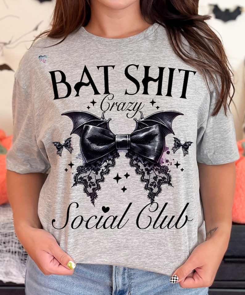 May include: Gray t-shirt with a black bat design and the text "Bat Shit Crazy Social Club".