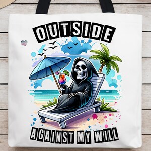 May include: A white tote bag with a black handle and a graphic of a skeleton sitting in a beach chair with a tropical drink. The text "OUTSIDE AGAINST MY WILL" is printed in black letters on the bag.