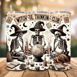 May include: Three beige tumblers with the text "WITCHFUL THINKING CLUB" and illustrations of skeletons wearing witch hats. The skeletons are seated around a globe, books, and potion bottles. Each tumbler has a straw.