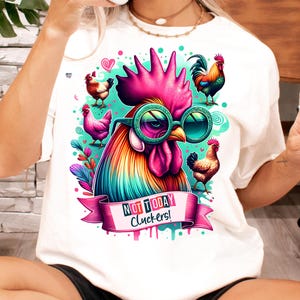 May include: White t-shirt with a colorful rooster wearing sunglasses and the text "Not Today Cluckers!" printed on it.