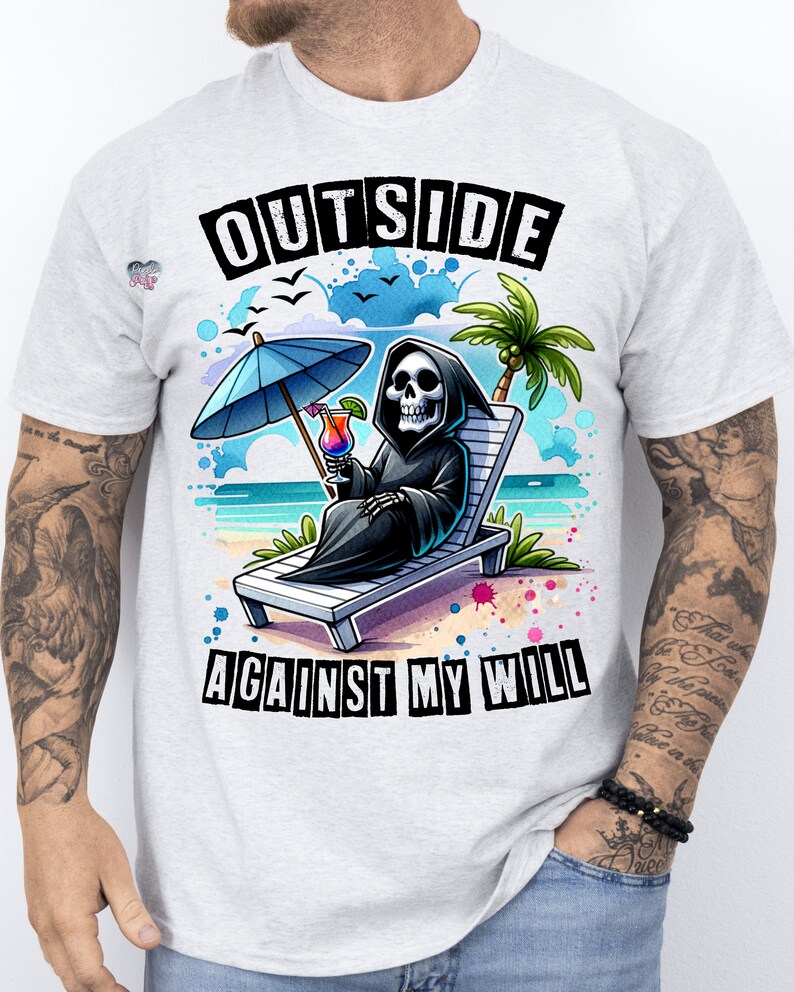May include: A white t-shirt with a graphic of a skeleton sitting on a beach chair with a cocktail and an umbrella. The text "OUTSIDE AGAINST MY WILL" is printed on the shirt.
