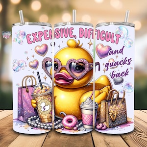 May include: A white tumbler with a yellow rubber duck wearing pink sunglasses and holding a pink and white iced coffee. The tumbler has a pink and purple glitter design and the text "EXPENSIVE, DIFFICULT and quacks back".