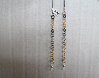 May include: Two pairs of black and gold chain eyeglass holders with clear plastic ends. The tag reads "234".