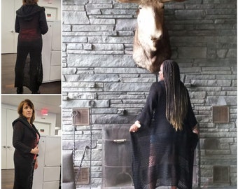 May include: A long, black, open-front cardigan featuring a hood and a semi-sheer, crocheted knit pattern. The garment has long sleeves and extends to the lower calf, showcasing a lightweight, breathable texture throughout the entire design.