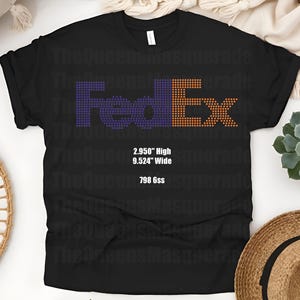 May include: Black t-shirt with the FedEx logo in purple and orange dot patterns. The text "2.950" High", "9.524" Wide", and "798 6ss" is printed below the logo. The shirt is displayed on a white surface.