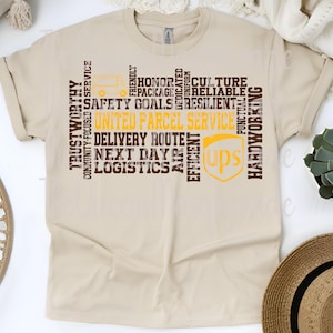 May include: A beige t-shirt featuring the UPS logo and text. The text includes "United Parcel Service," "Delivery Route," and other words associated with the company. The design incorporates a truck graphic and various keywords.