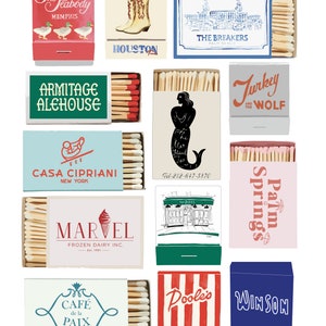 May include: A collection of matchbox labels featuring various designs, including a hotel, a restaurant, a frozen dairy company, a cafe, and a mermaid. The matchboxes are all in different colors and styles.