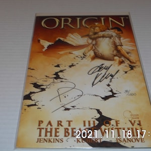 May include: A comic book cover with a yellow, orange, and brown background. The title "ORIGIN" is printed in gold letters. The cover features a drawing of two people embracing. The comic book is signed by the artists, "Barry Windsor-Smith" and "Mike Kubert". The comic book is numbered 39/1500. The text "PART III OF VI THE BEAST WITHIN" is printed on the bottom of the cover.