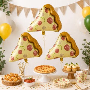 May include: Three pizza slice-shaped balloons with pepperoni and mushroom toppings float above a party table. A whole pizza, cupcakes, and party supplies are arranged on a table decorated with confetti and balloons. A festive party theme.