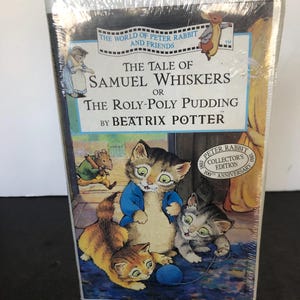 May include: A vintage VHS tape featuring the classic children's story "The Tale of Samuel Whiskers or The Roly-Poly Pudding" by Beatrix Potter. The cover features an illustration of three kittens playing with a ball of yarn. The tape is a collector's edition celebrating the 100th anniversary of Peter Rabbit.