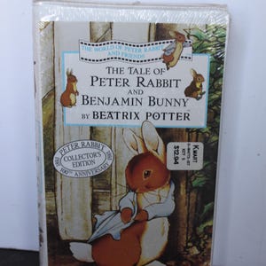 May include: A shrink-wrapped VHS tape titled The Tale of Peter Rabbit and Benjamin Bunny by Beatrix Potter. The cover features illustrations of rabbits, a Peter Rabbit Collector's Edition 100th Anniversary seal, and a Kmart price sticker.