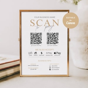 Peut inclure: Un panneau encadré avec le texte "SCAN to pay" en lettres dorées. Le panneau comprend deux codes QR, des logos de méthodes de paiement et des informations de contact professionnelles. Le panneau est dans un cadre doré et sur une surface claire.