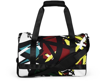 May include: A black and white duffel bag with a colourful abstract design. The bag features a black shoulder strap and handles. The design includes red, yellow, teal, and green geometric shapes on a white background.