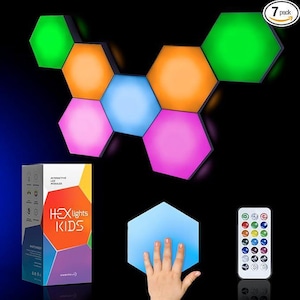May include: A 7-pack of hexagonal LED light modules in various colors, including green, orange, blue, pink, and white. The lights are arranged in a pattern on a black background. The box in the lower left corner says "Hex Lights Kids".
