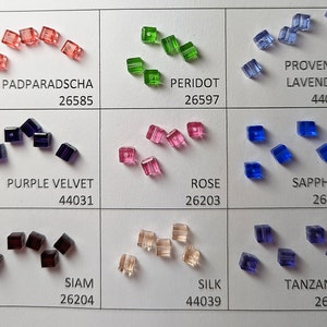 May include: A chart with 10 different colors of square glass beads. Each color has a name and a number. The colors are: Padparadscha, Peridot, Provence Lavender, Purple Velvet, Rose, Sapphire, Siam, Silk, Tanzanite.
