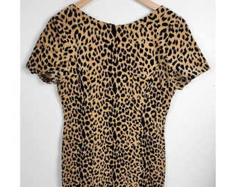 May include: A short-sleeved dress with a leopard print pattern in shades of brown and black.