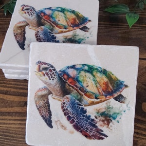 May include: A set of four white ceramic coasters with a colorful watercolor painting of a sea turtle on each coaster.