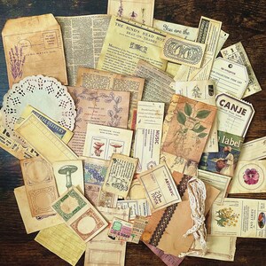 May include: A collection of vintage ephemera, including paper scraps, labels, and tags, with various designs and text. The items are in shades of brown, cream, and white, with some featuring floral motifs and handwritten text.