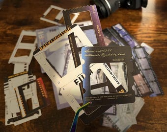 May include: A set of black and white film negative frames with the text "Backlighting" and "Spices and 15355 botanicals Roasted by hand 1653/02/24" printed on them.