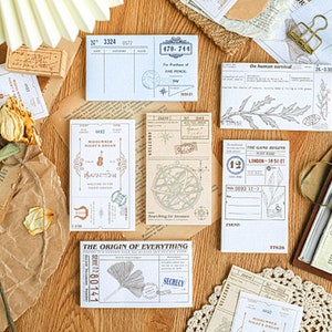 May include: A collection of vintage-style paper ephemera with various designs and text, including "The Game Receipts London 1050-27", "The Origin of Everything", and "Midsummer Night's Dream".