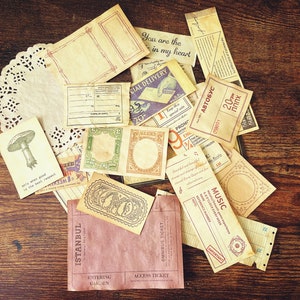 May include: A collection of vintage-style paper ephemera with various designs and text, including "You are the in my heart", "Special Delivery", "Music", "Istanbul", and "Entering Garden".