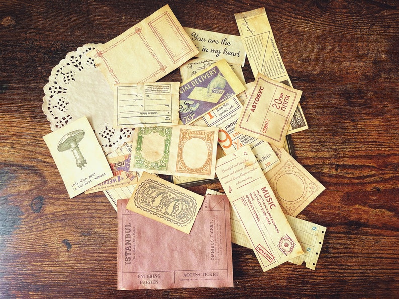May include: A collection of vintage-style paper ephemera with various designs and text, including "You are the in my heart", "Special Delivery", "Music", "Istanbul", and "Entering Garden".