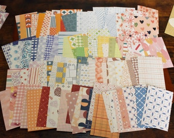 May include: A collection of 50 patterned paper sheets in various colors and designs, including geometric, floral, and abstract patterns. The papers are perfect for scrapbooking, card making, and other craft projects.