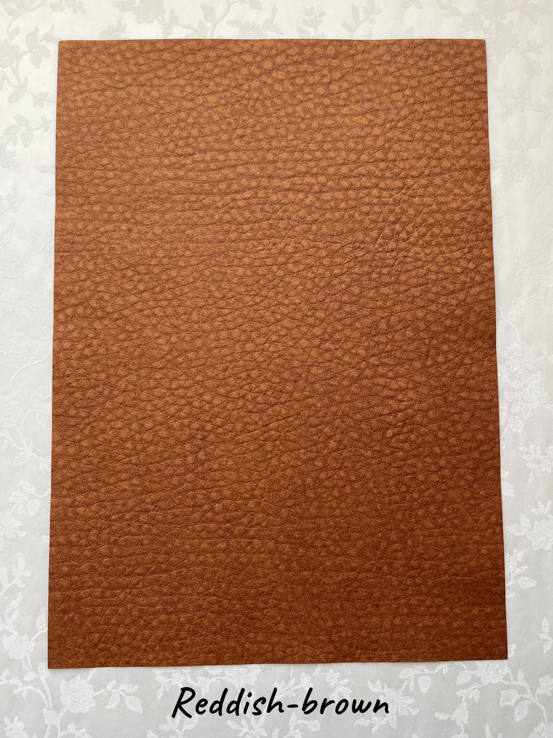 May include: A reddish-brown sheet of textured material. The surface has a bumpy, leather-like appearance. The text "Reddish-brown" is printed in a cursive font at the bottom of the image. The material is likely used for crafting or design projects.