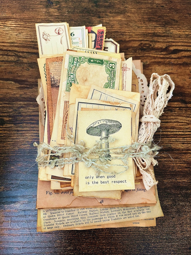 May include: A stack of vintage ephemera, including postcards, tickets, and paper scraps, tied together with twine. The ephemera is mostly brown and cream colored with some green and red accents. The top piece of ephemera has the text "only when good is the best respect".