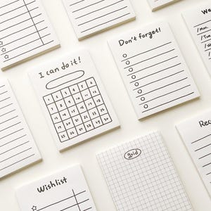 May include: A set of white sticky notes with different designs and layouts. The notes include a calendar, a checklist, a grid, a wishlist, a note, a receipt, and a weekly planner. The notes are perfect for organizing and planning.