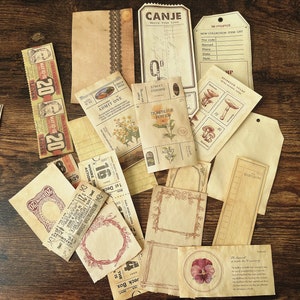 May include: A collection of vintage-style paper ephemera, including tickets, tags, and labels. The paper is cream-colored with brown and black ink. The text on the paper includes "CANJE", "ADMIT ONE", "TICKETS FOR HEAVEN", "STREET ADDRESS", "NO COLLECTION ITEM LIST", and "20".